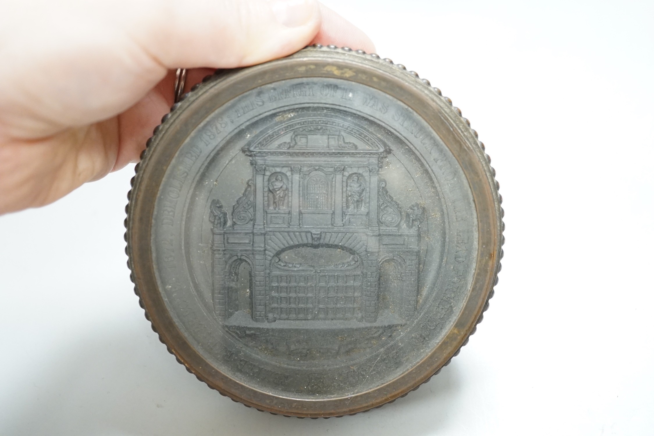 Temple Bar commemorative cast lead and brass paperweight, ‘Temple Bar: erected 1672, demolished 1878; this effigy of it was struck from the lead formally on the roof’ and a 19th century gilt metal relief glass cased pape